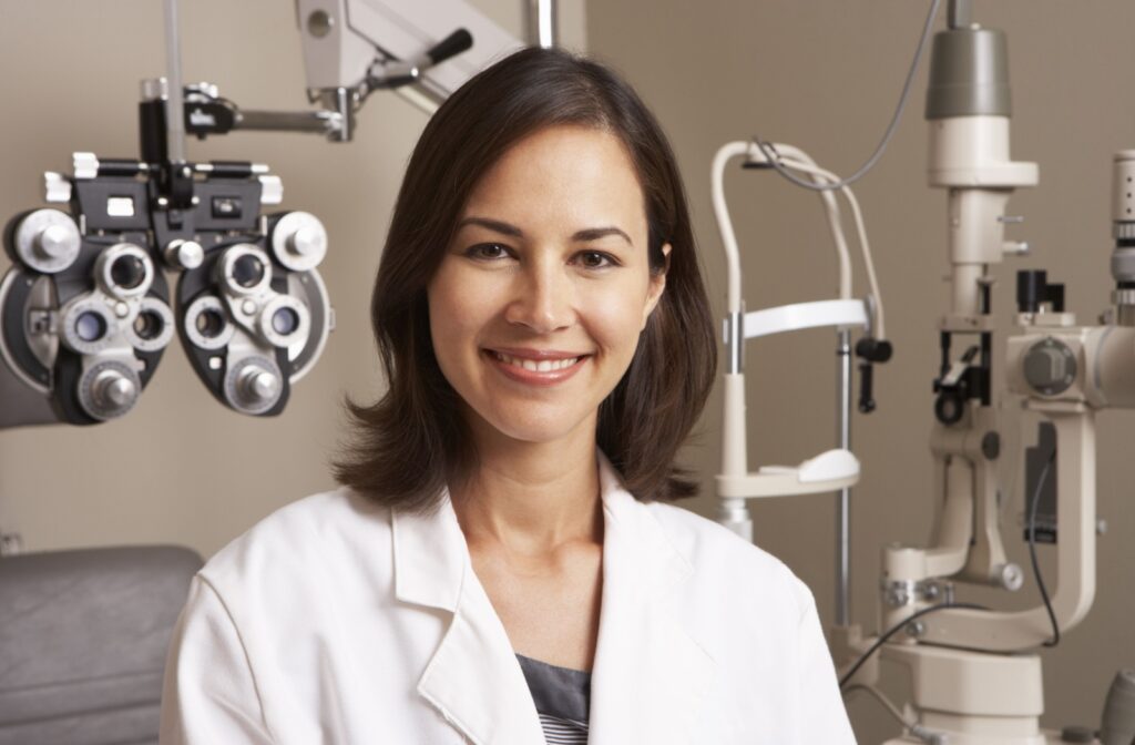 An image of a smiling optometrist with medical equipment as the backdrop, ready to help their next patient.