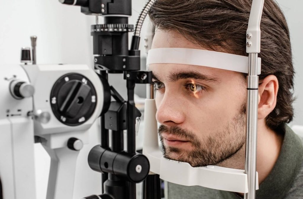 A patient having their eyes examined by an optometrist to monitor for color blindness.